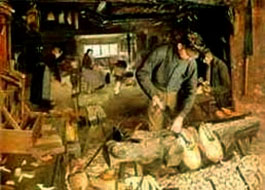 Ölgemälde: Holzschuhmacher-Werkstatt in der einige Männer und Frauen arbeiten