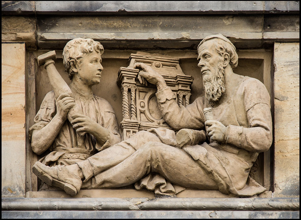 Steinrelief: Schreinermeister und Lehrjunge