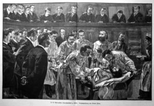 sw-Abbildung: Patient im Hörsaal umringt von Chirurgen und Medizinstudenten