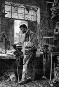 Schlosser in seiner Werkstatt am Schraubstock