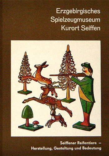 Heftcover: Holzfiguren zum Thema Jagd