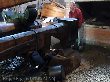 Video: Mann bearbeitet Eisen mittels großem Stangenhammer