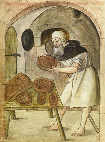 Buchmalerei: Buel steht vor Tisch mit fertigen Lebkuchen und hält einen weiteren großen in Händen - 1520