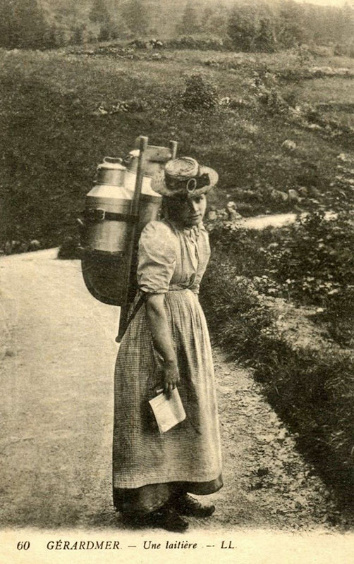 Ansichtskarte: Frau mit Kraxe und Milchkannen auf dem Rücken